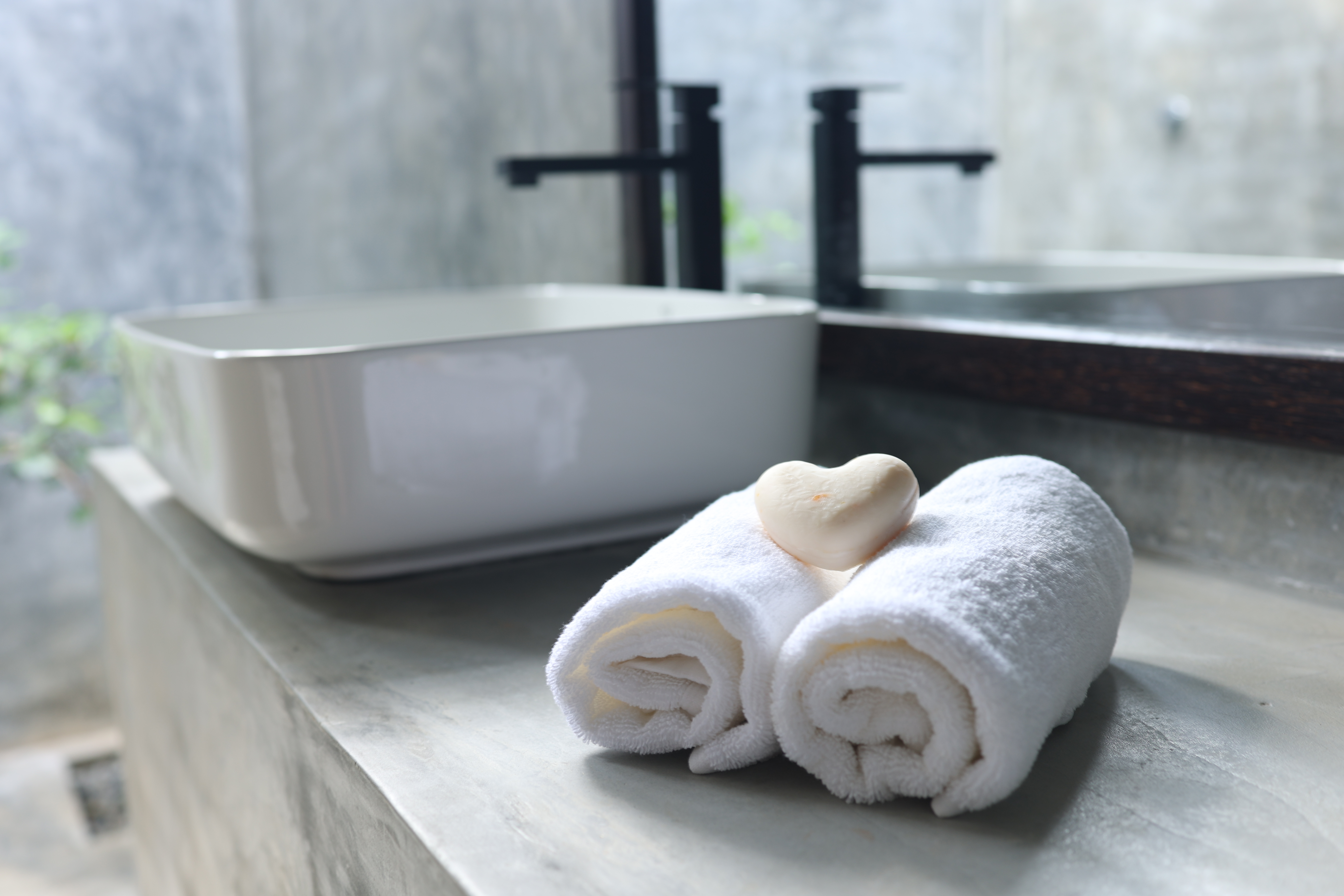 Bathroom vanity — vessel sink, black tap, fresh towels