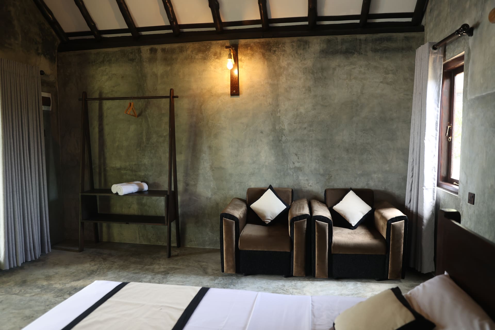 Sitting area with wardrobe rack and warm wall lamp