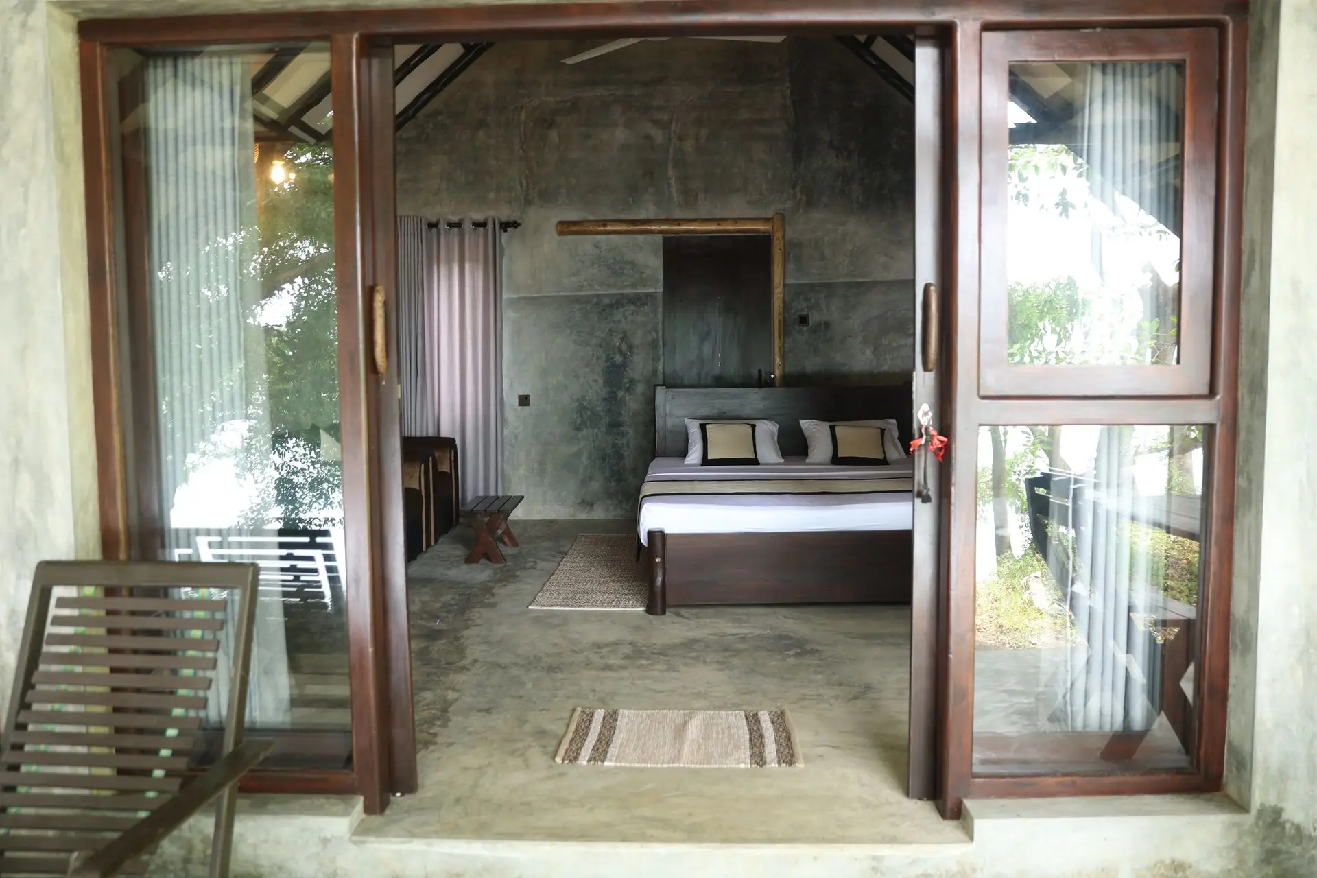 Wide-open cottage doors looking into the bedroom