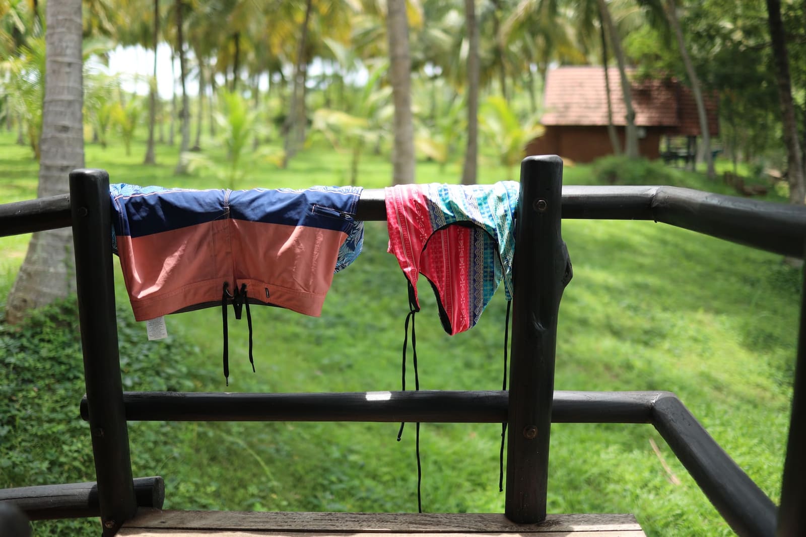 Swimsuits drying on the veranda railing after a swim in the lake