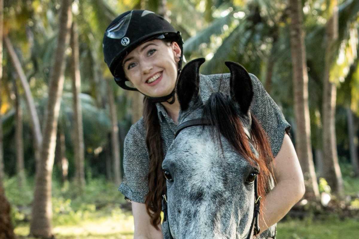 A guest horse riding under palms near Aji Fruit Farm, Embilipitiya
