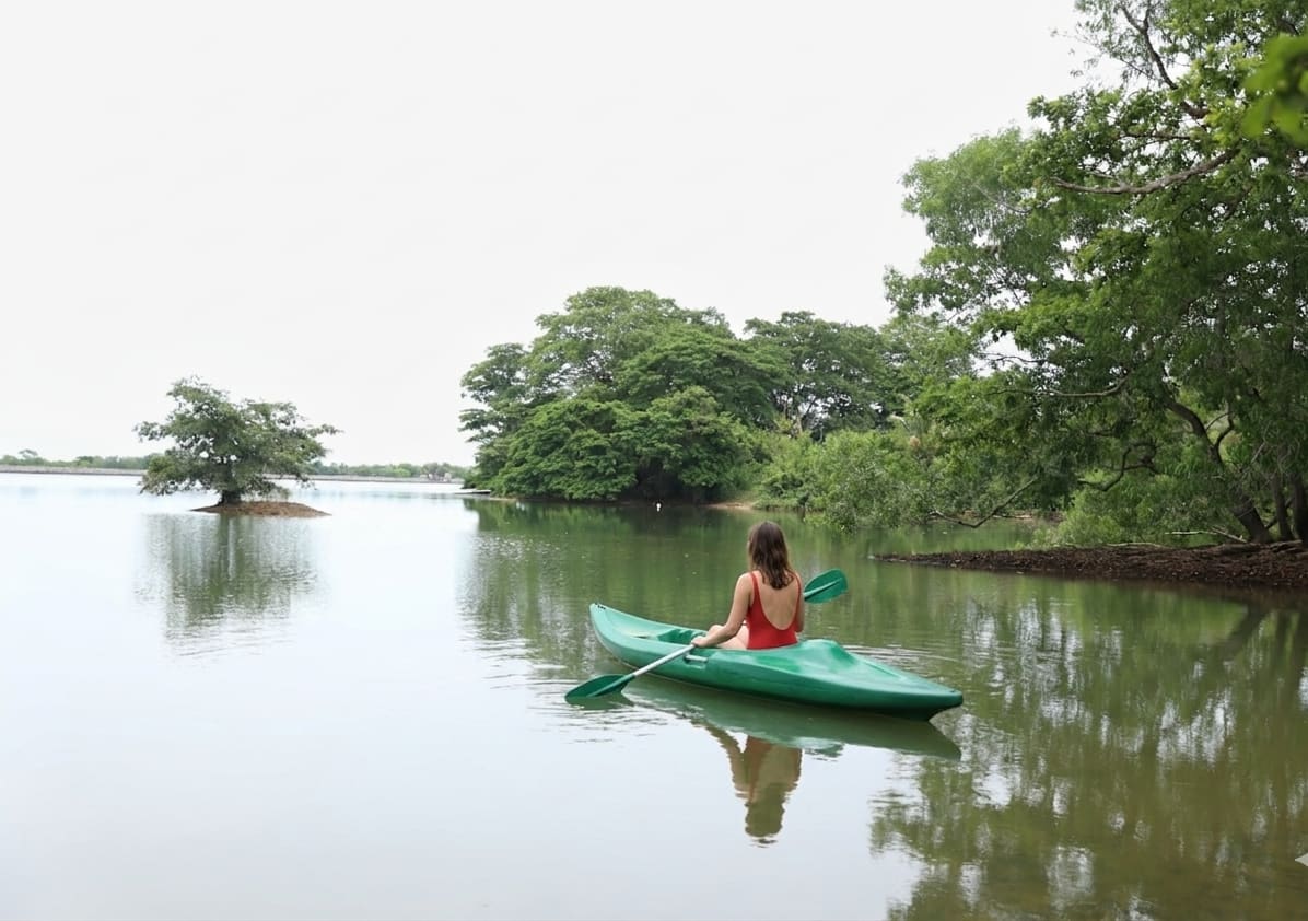 A guest paddling a kayak on the lake at Aji Fruit Farm — Embilipitiya, Sri Lanka