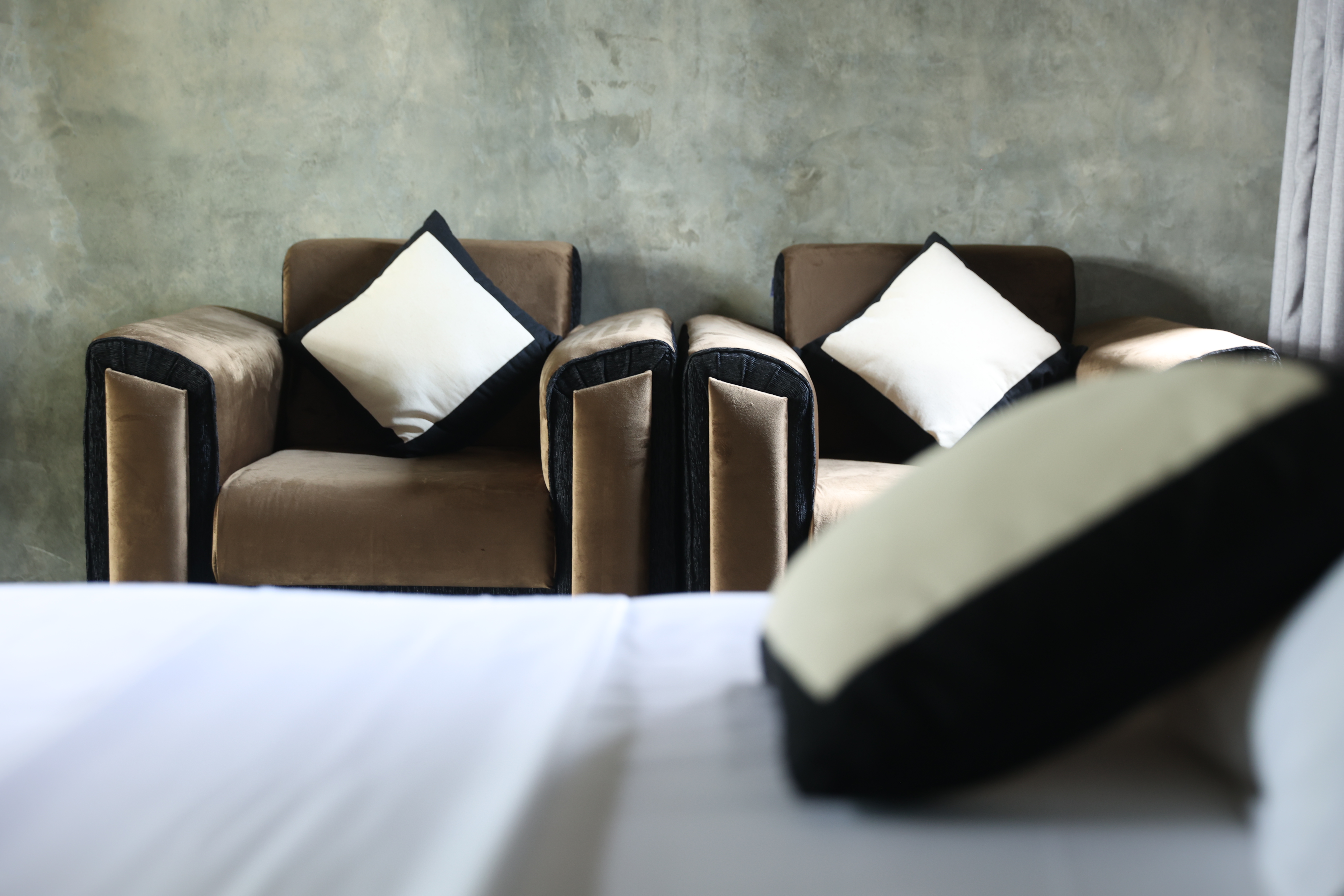 Sitting area — velvet armchairs on concrete